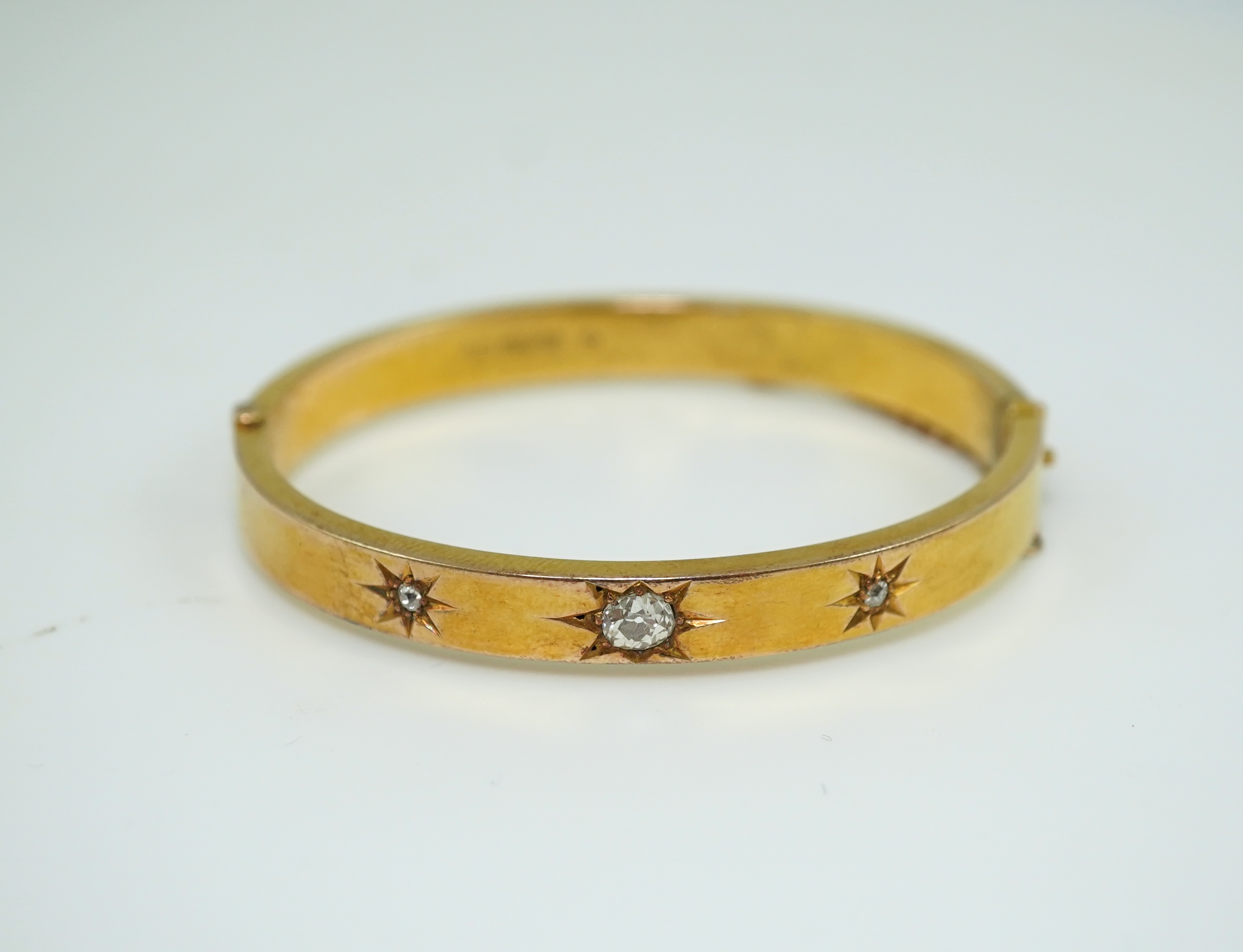 An Edwardian 15ct gold and diamond bangle, circa 1904